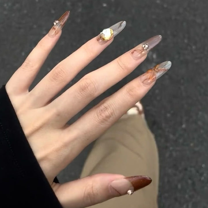 Glamorous artificial nails with creative embellishments Kalsten