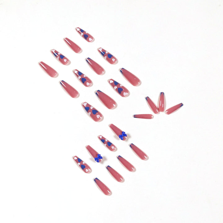 Artful stiletto nails with modern heart and bow motifs Kalsten
