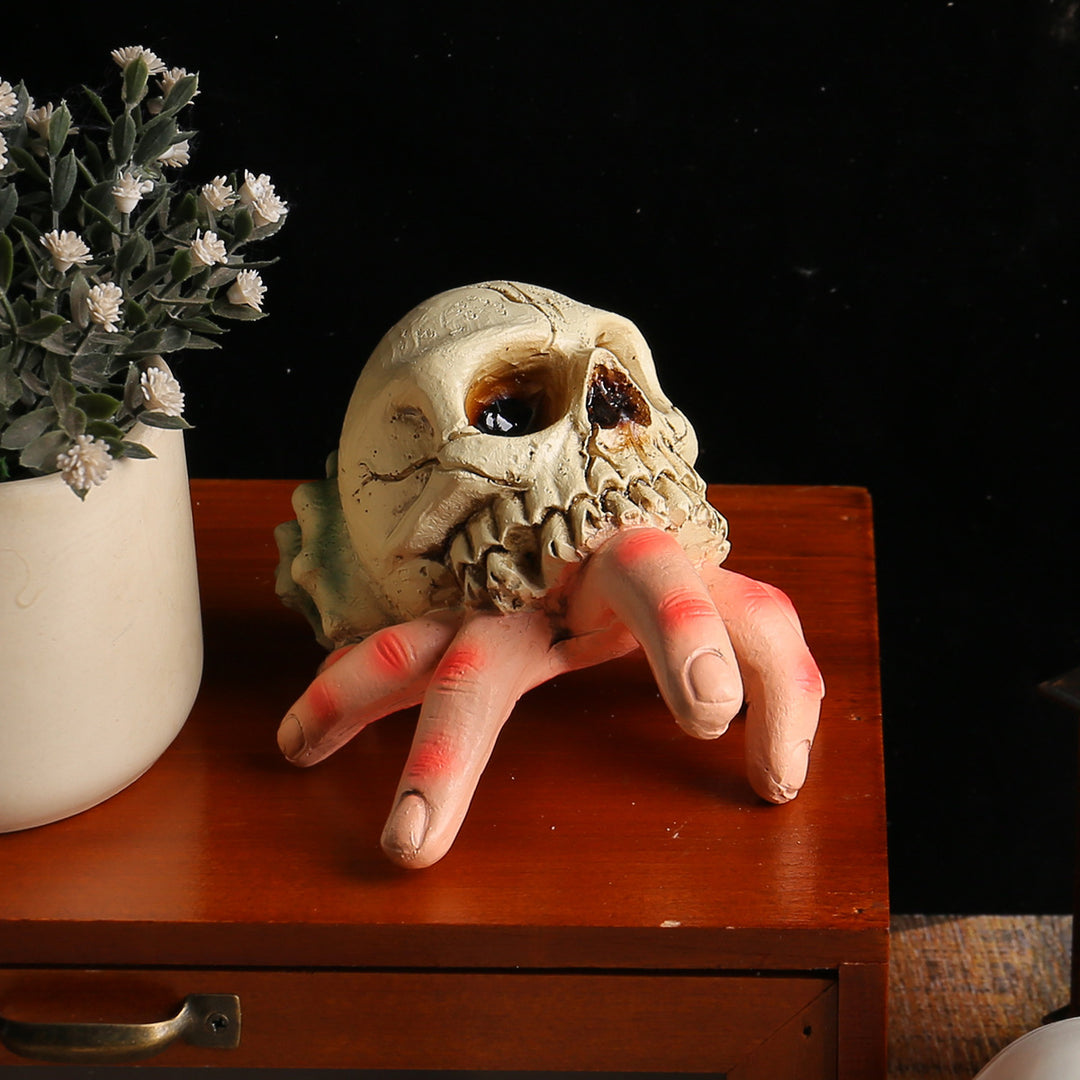 Detailed Halloween decoration sculpture skull with grasping hand