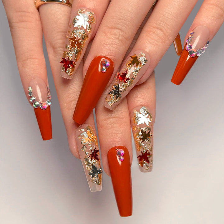 Glamorous acrylic nails with leaf design and glitter accents Kalsten