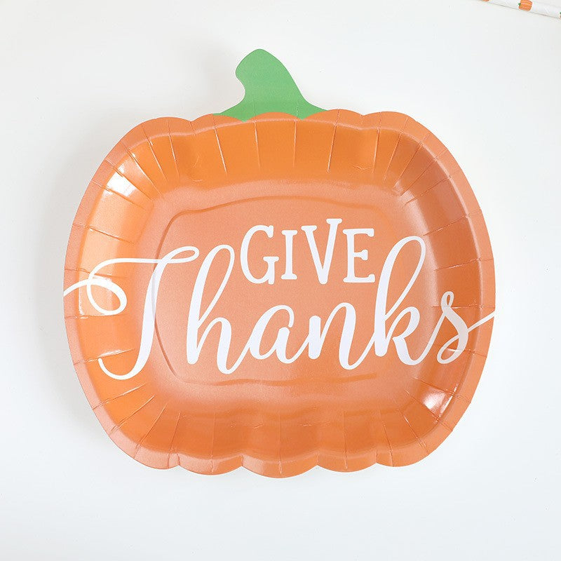 Disposable paper plates in pumpkin shape with spooky face design