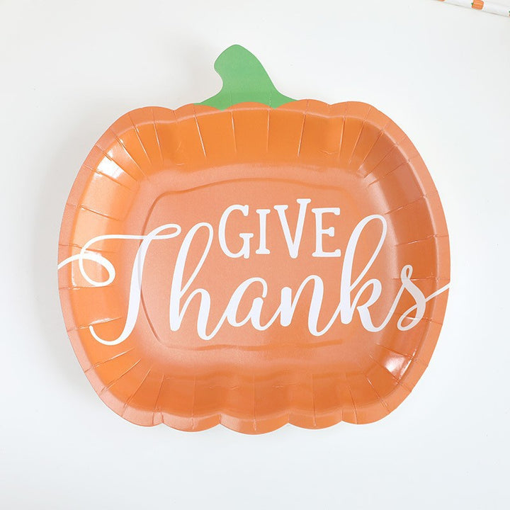 Disposable paper plates in pumpkin shape with spooky face design