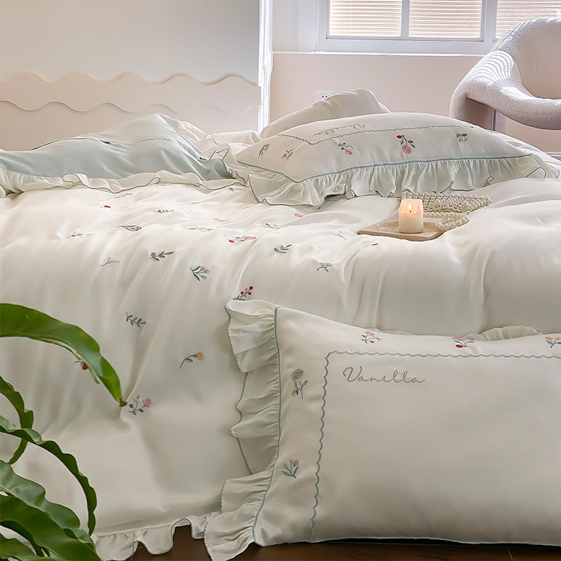 Romantic cotton satin bedding set with delicate floral embroidery and ruffle trim