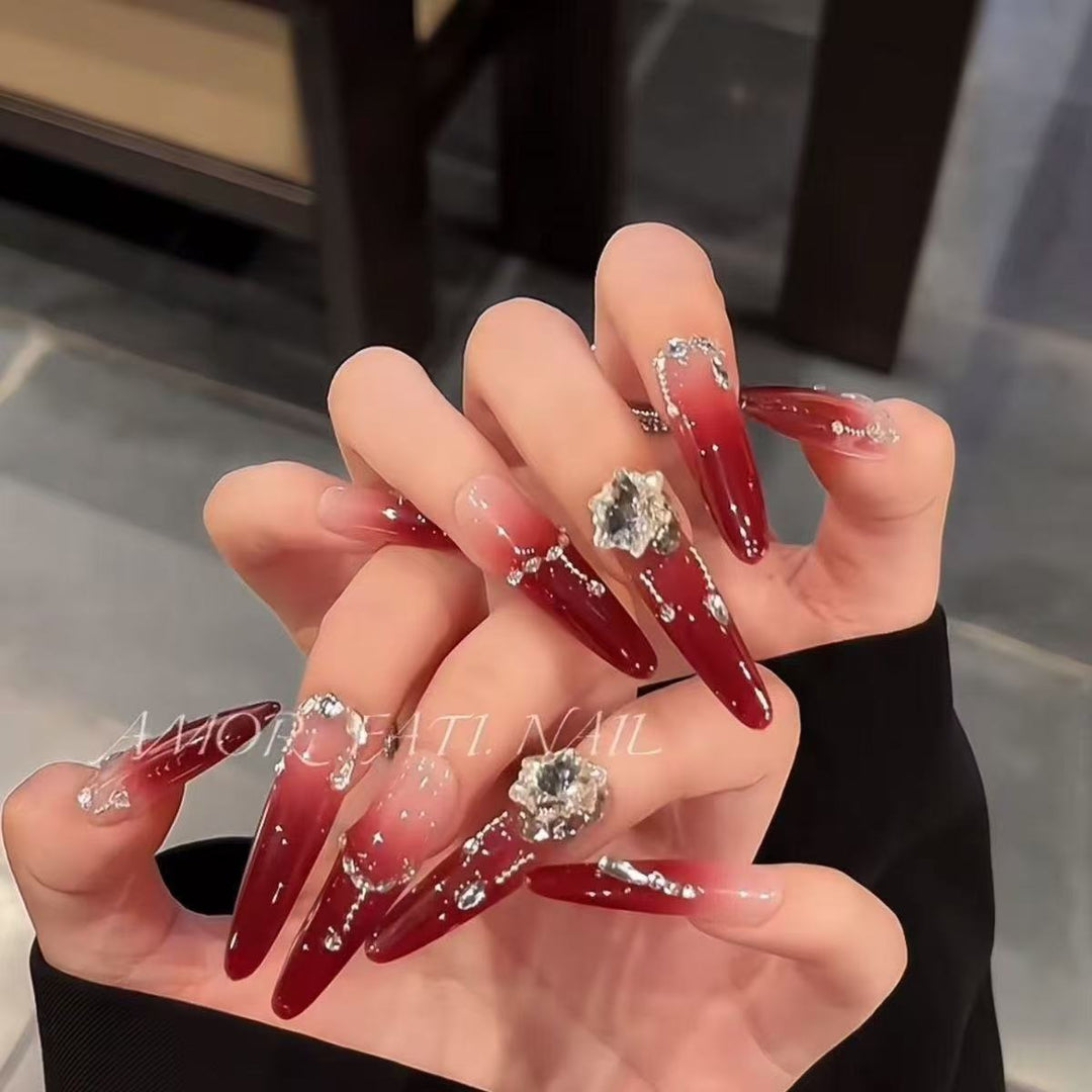 Acrylic nail set with elegant tips and glamorous rhinestone accents Kalsten