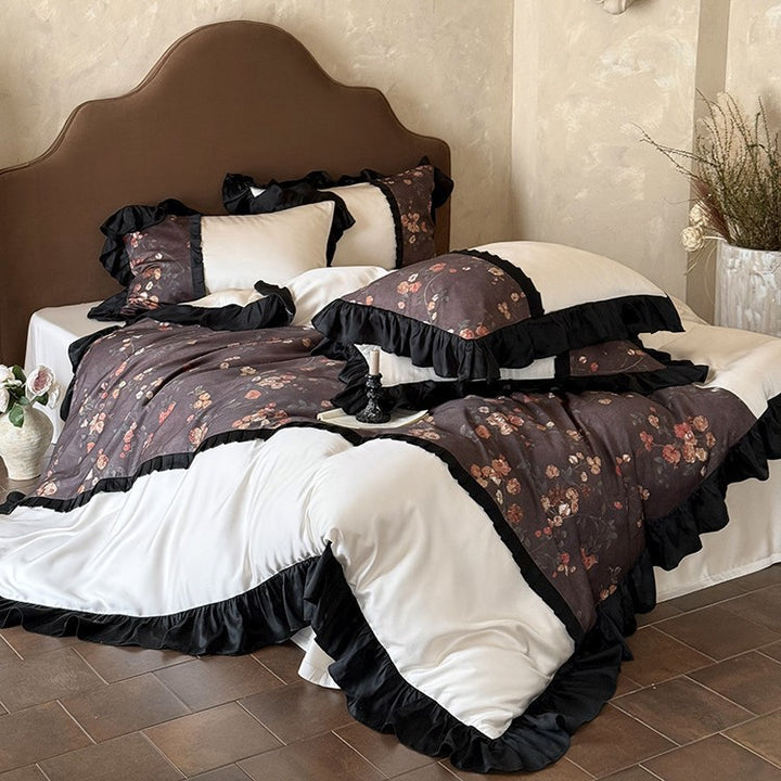 Reversible cotton satin bedding set with floral design and decorative ruffle trim