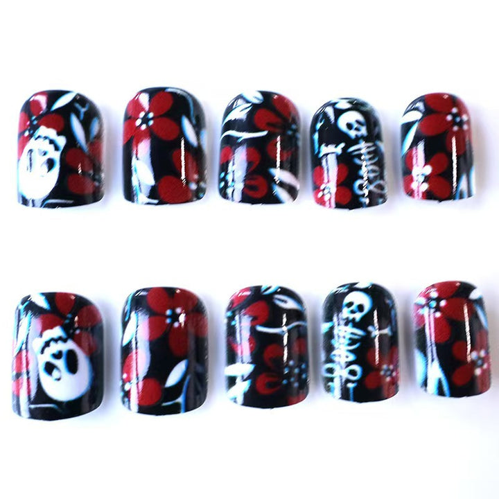 Creative nail art with skull motif and floral elements Kalsten