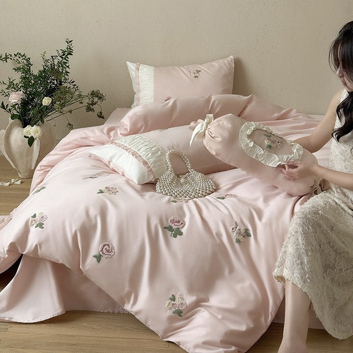 Luxurious cotton bedding set with delicate rose embroidery and ruffles