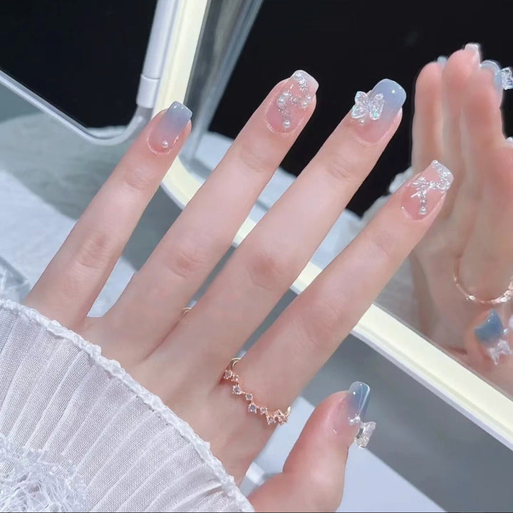Artistic nail decoration with glitter and butterfly details Kalsten