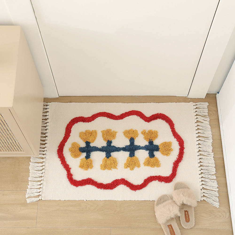 Handwoven cotton bath mat rug with tufted flower appliqué and tassels Kalsten