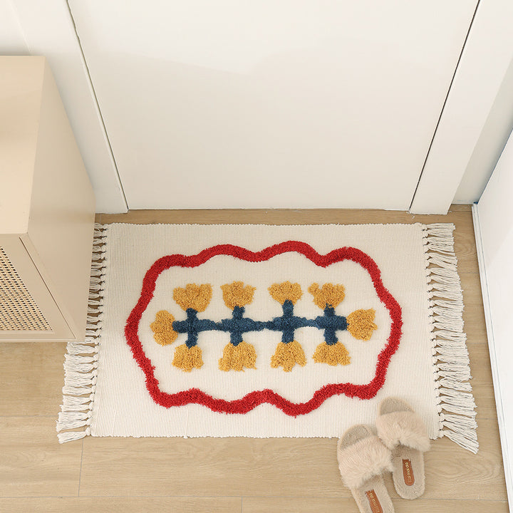 Handwoven cotton bath mat rug with tufted flower appliqué and tassels Kalsten