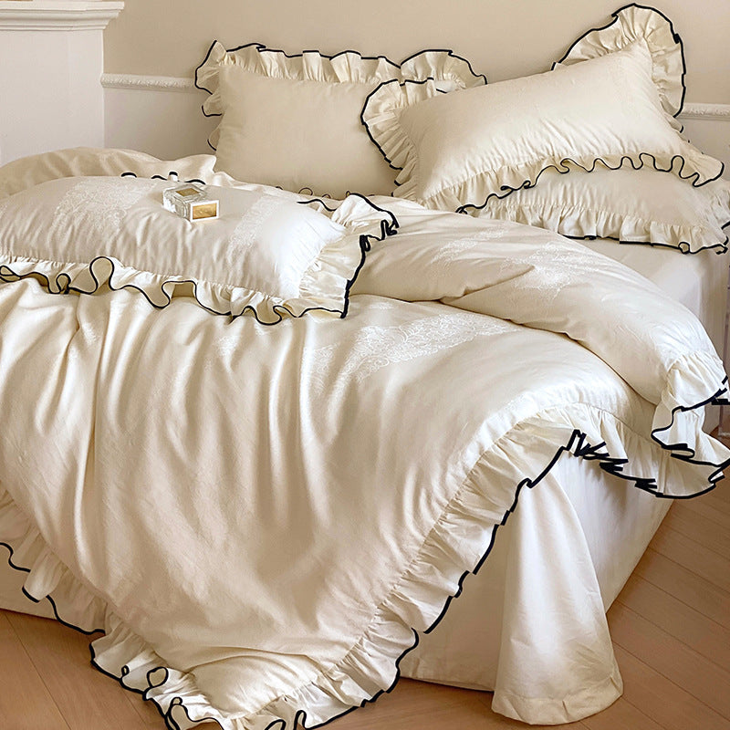 Noble cotton satin bedding set with flounce ruffles, jacquard floral border and contrasting piping.