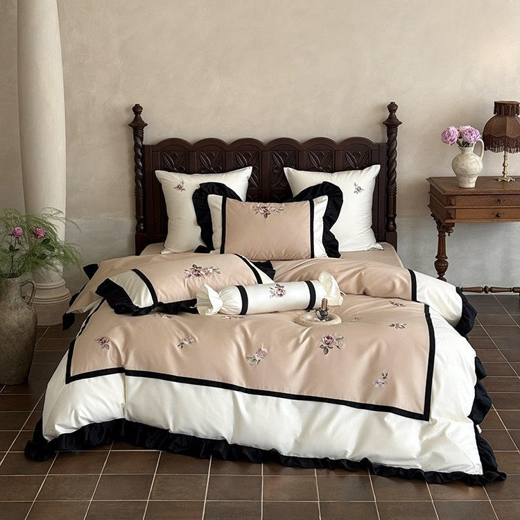 Luxurious embroidered bed linen set made of cotton satin with ruffles and decorative pillows