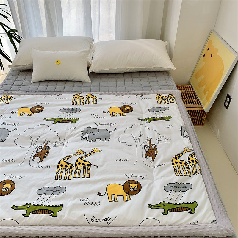 Children's quilt with colorful dinosaur print and soft minky border