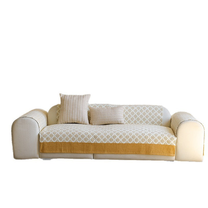 Knitted sofa cover with jacquard pattern and reinforced hem border Kalsten