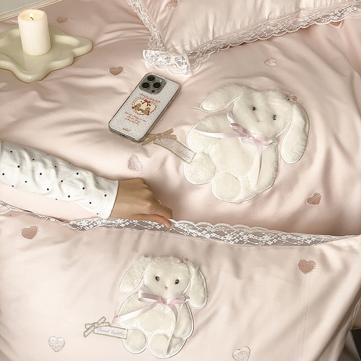Luxurious satin bedding set with plush bunny appliqué and lace trim