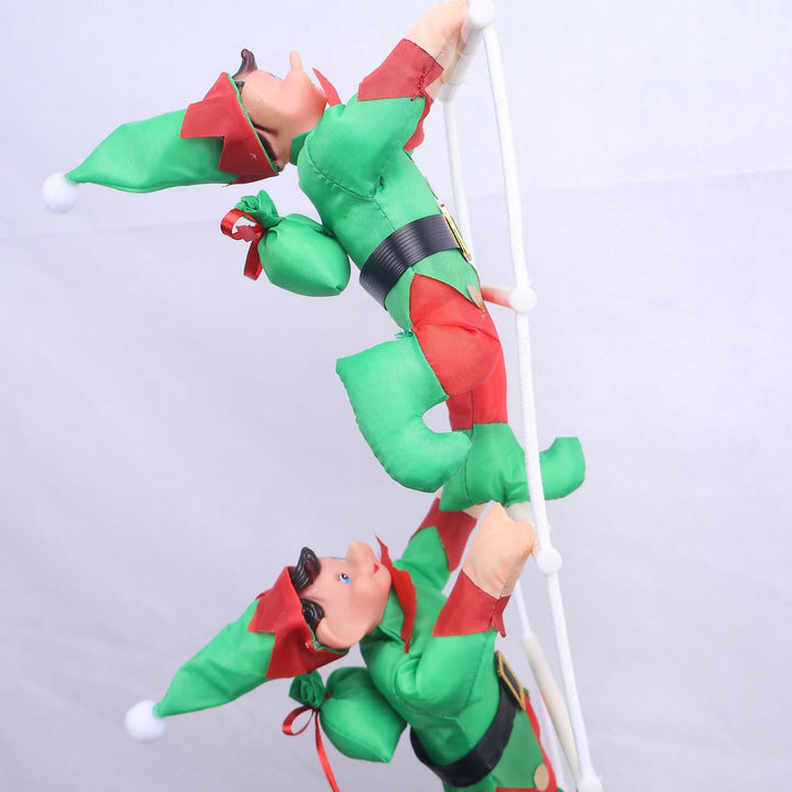Inflatable Santa Claus figures climbing ladder
