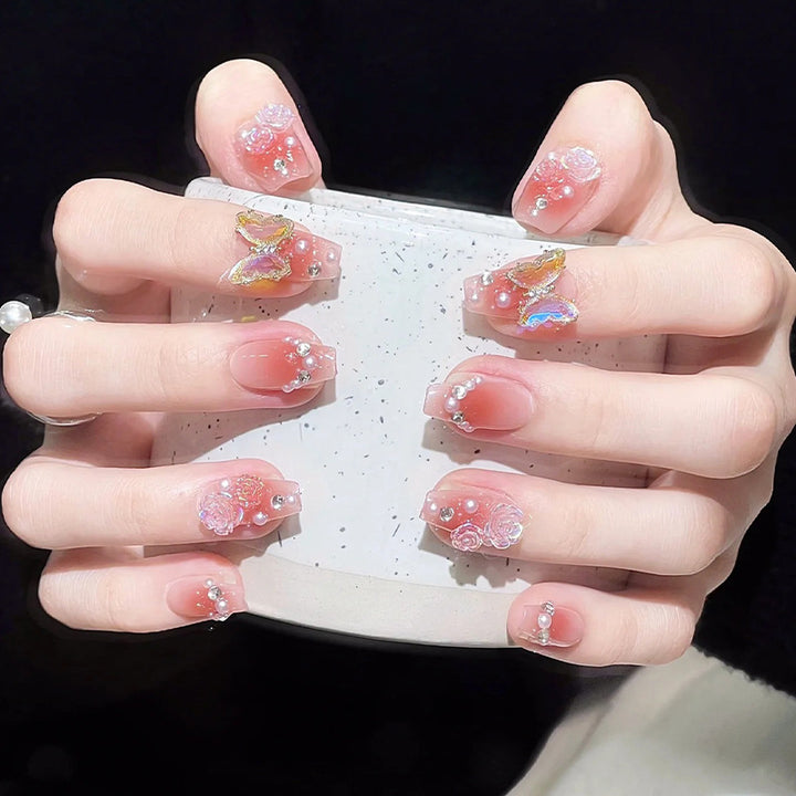 Glamorous artificial nails with delicate flower and glitter effects Kalsten