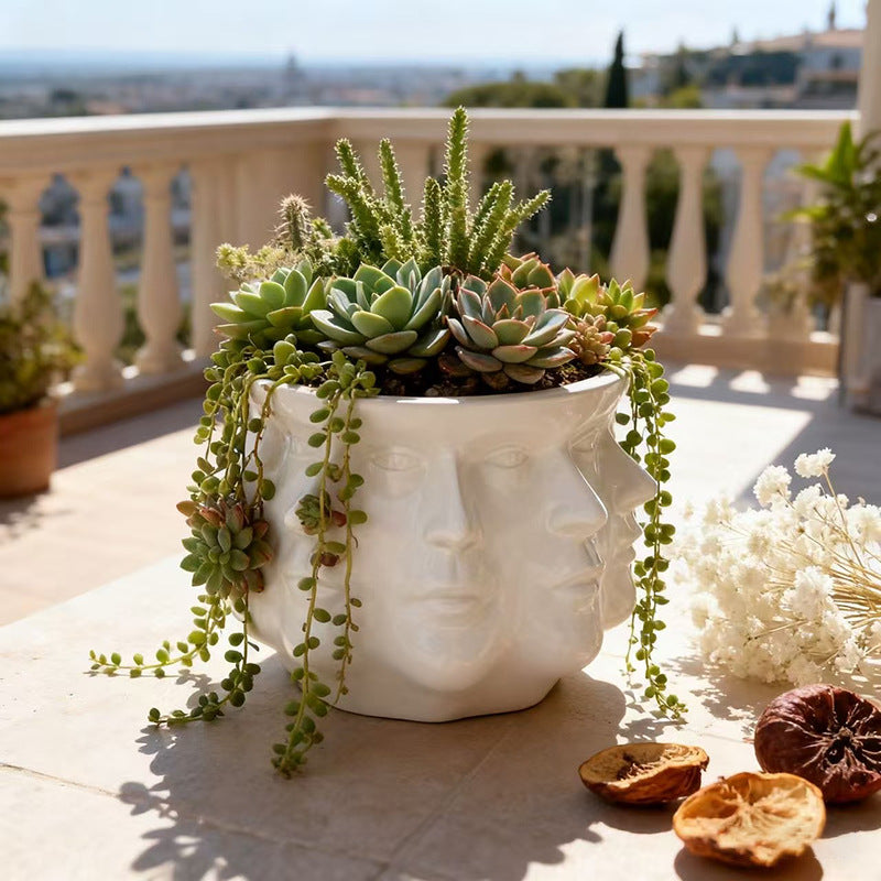 Modern flower pot with geometric face pattern