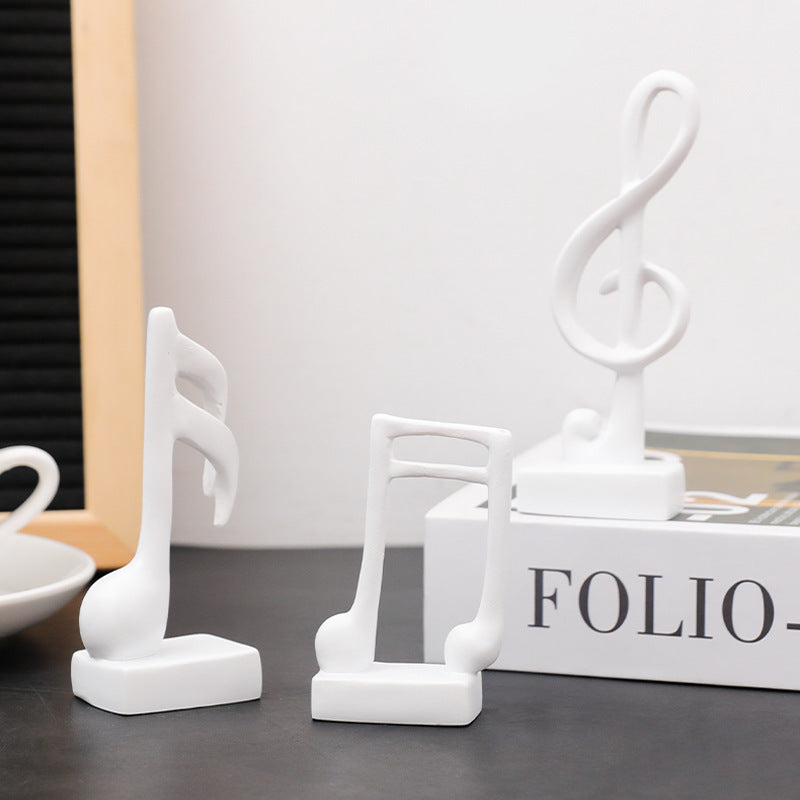 Three music note figures, resin, modern