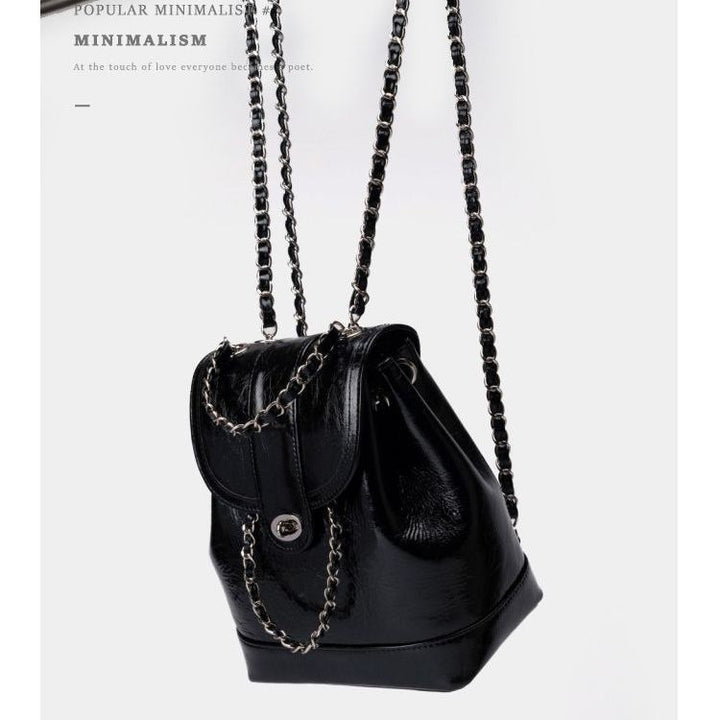 Compact backpack made of PU with chain decoration