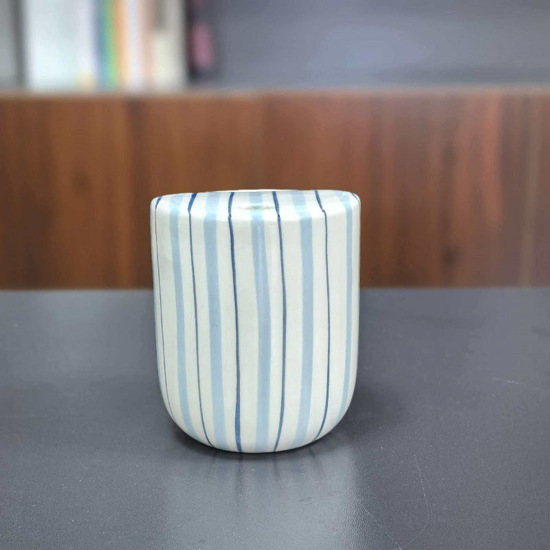 Ceramic coffee mug with stripes and heart design