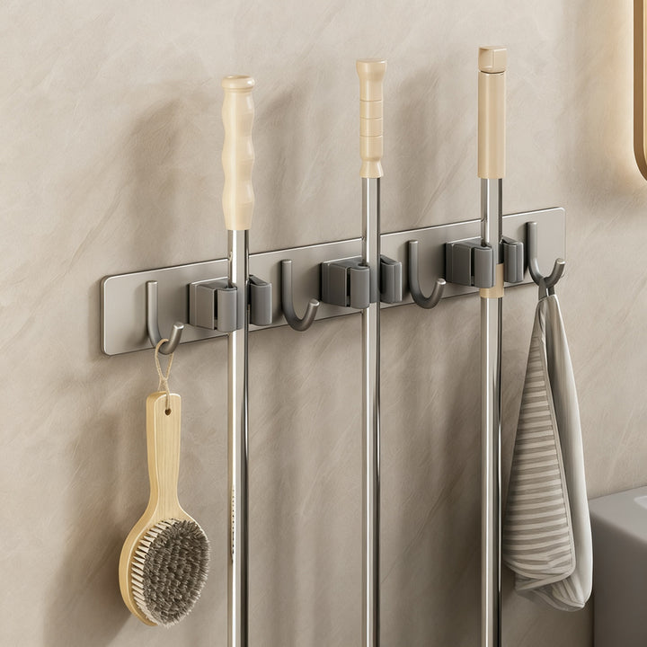 Wall bracket for brooms and mops made of stainless steel