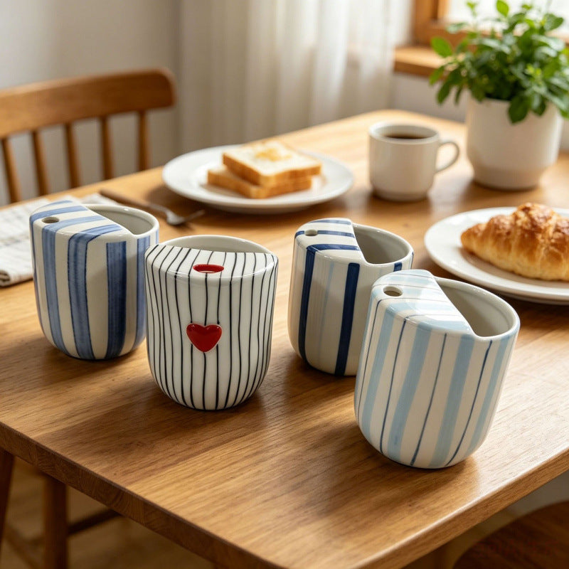 Ceramic coffee mug with stripes and heart design